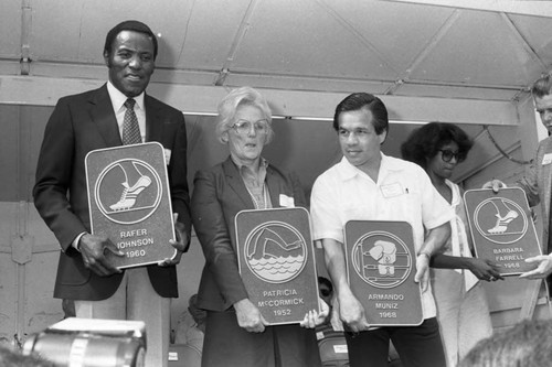 Rafer Johnson, Pat McCormick, Armando Muniz, and Barbara Ferrell posing together, Los Angeles, 1983