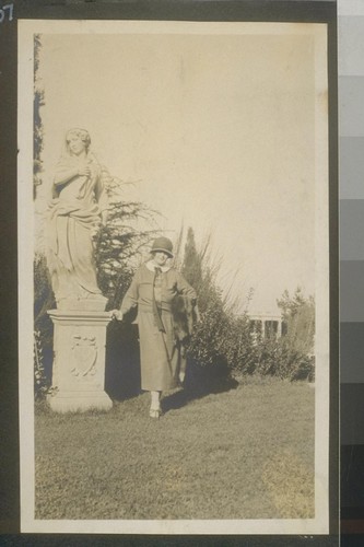 [Woman by statue]