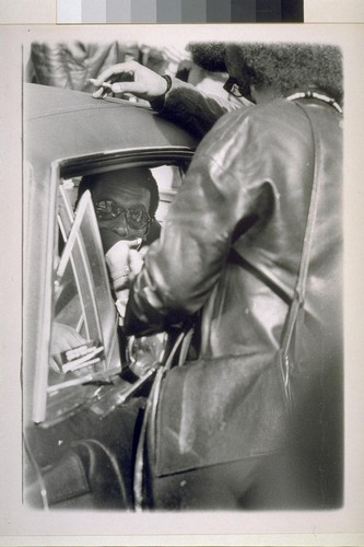 Stokely Carmichael in back seat of car with Kathleen Cleaver