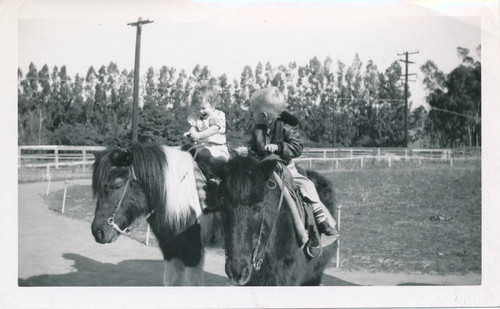 Two children riding ponies on Chandler Ranch