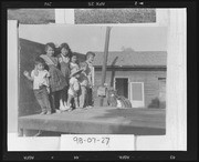 Children posed on a flatbed truck on family farm
