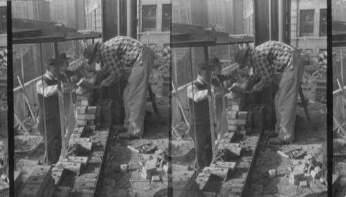 Bricklayers at work in a 22nd story bldg. at 111 John St. Lower New York, N.Y. City