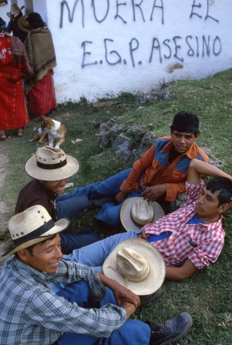 Mayan men rest near a wall with graffitil, Chajul, 1982