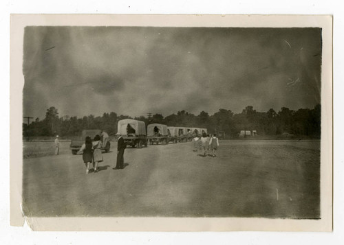 Covered trucks leaving Jerome camp for Tule Lake camp