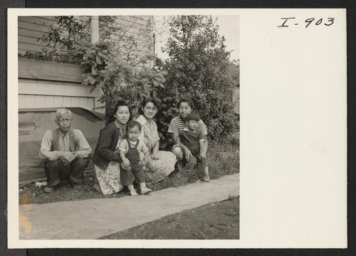 The Sukemon Itami family, formerly from Heart Mountain, is shown in front of their Portland home. Left to right: Mr