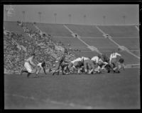 Football game between the UCLA Bruins and a Washington team at the Coliseum, Los Angeles