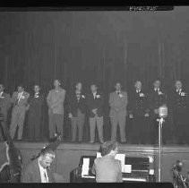 Unidentified group of men on a stage
