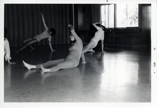 Three women exercising in a large room