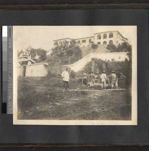 Laborers hauling lumber in front of the missionary compound, Ing Tai, Fujian, China, ca. 1910