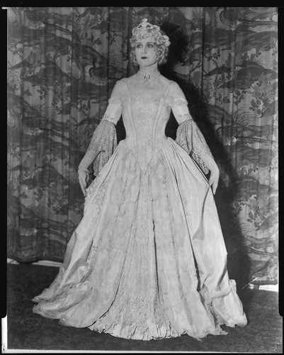 Peggy Hamilton modeling a period gown and crown at a fashion show at ...