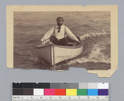 Emerald (yacht) crew member in small boat. [photographic print]