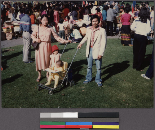 Mien family with child in stroller