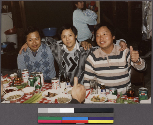 Three men sitting at a dinner party