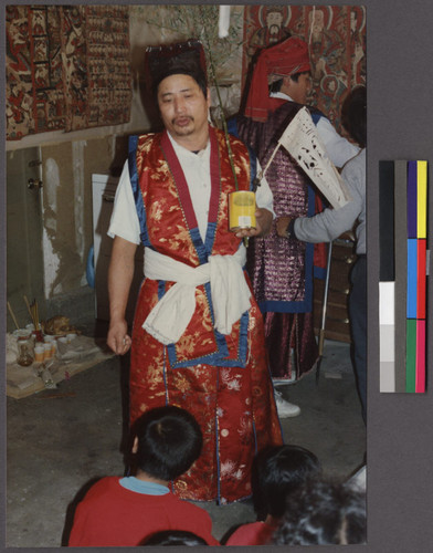 Man in traditional dress at a Mien religious rules ceremony, Northern California