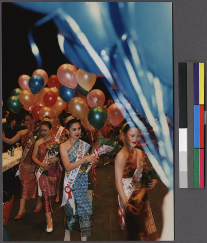 Lao beauty pageant contestants holding balloons at a New Year's party