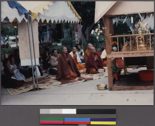 Buddhist monks and community members at the opening ceremony for a Lao New Year's party