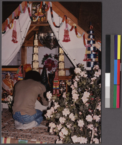 Man praying at a Buddhist structure, Ceres, California