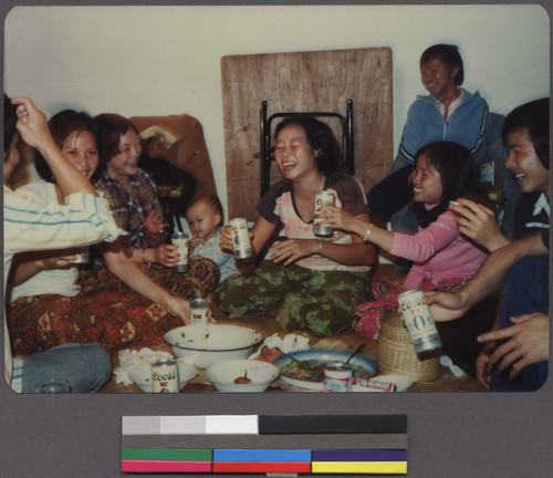 Women laughing and drinking at a gathering