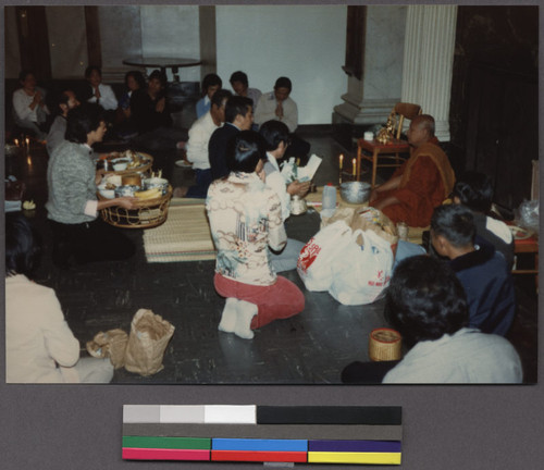 Making offerings to a Buddhist monk, Northern California