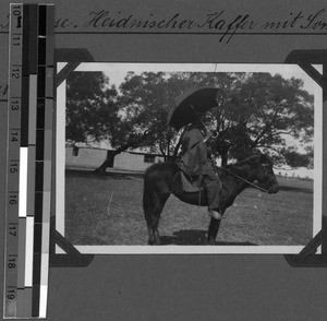Man with sunshade on a horse, Tabase, South Africa East, 1932