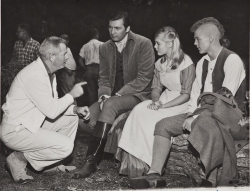 Fess Parker, Sue Lyon and James MacArthur listen to the director, 1957