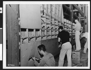 Four men working inside the Lockheed Corporation plant, ca.1945