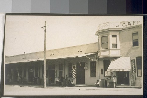 Sacramento Chinatown. [People resting on sidewalk in Chinese commercial district.]