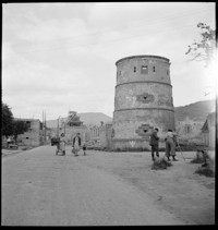 [Miscellaneous People: round tower in war damaged village]