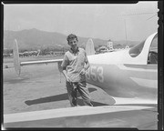 Man smiling next to small plane