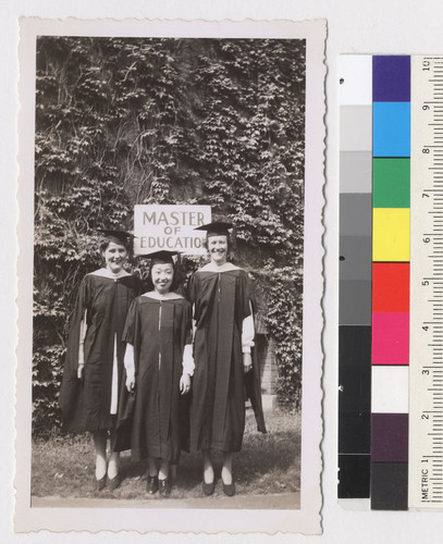 Here are the 3 M. Ed's. The sign was put there to indicate where we were to line up for the procession into the bldg. where we had the grad exercises. Left to right--Bodil Jorgensen--Danish student--me--Ruth T .. [illegible]--P.E. major. Both swell girls