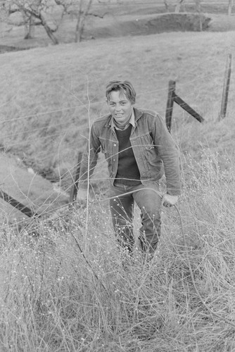 Young man with rope near fence, Berryessa Valley