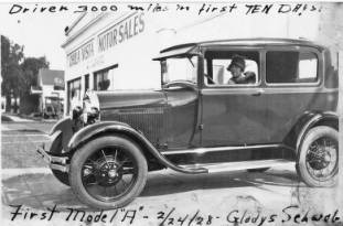 Gladys Schweb in her Model A Ford in front of Chula Vista Motor Sales