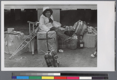 Young child sitting on a box