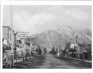 View of Second Avenue (Main Street?) looking north in Upland, showing Mount Baldy in the background, ca.1900