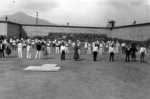 Prisoner athletes and performers lined up on field, with Mt. Tamalpais in the distance, San Quentin Little Olympics Field Meet, 1930 [photograph]