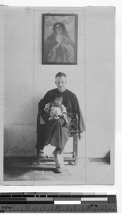 Fr. Phillip A. Taggart and a baby at Yangjiang, China, 1930
