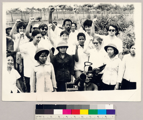 Eldridge Cleaver and U.S. People's Anti-Imperialist Delegation giving raised fist salute, North Vietnam