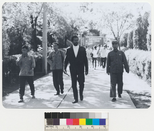 Eldridge Cleaver walking along path in China