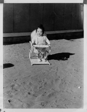 Baby in jumper chair at Granada Relocation Center