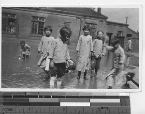 Children play after a heavy rain at Fushun, China, 1934