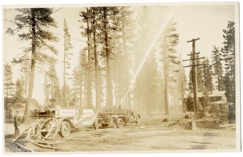 Fire engine spraying water from hose, California