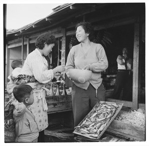 Woman making a purchase at a store, South Korea 1956-59