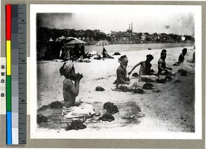 Hindu men sitting in the hot sun with five fires around them to seek religious merit, Vārānasi , India, ca. 1920