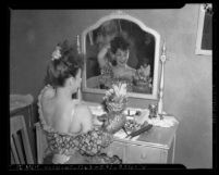 Actress Carmen Miranda at dressing table with her fruit hat, Los Angeles, Calif., circa 1941