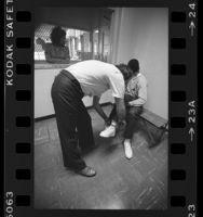 Officer removing manacles from a boy in Los Angeles County Juvenile Hall, 1984