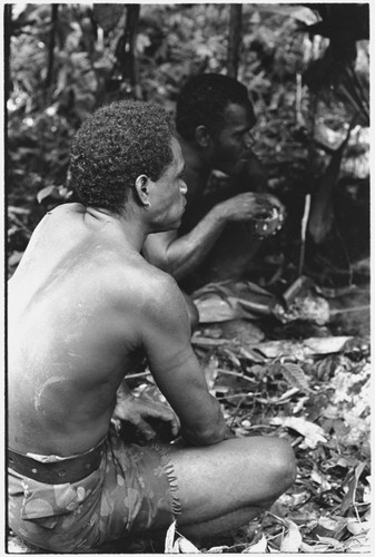 Men eating the ritual pudding
