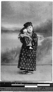 Girl holding a doll, Japan, ca. 1920-1940