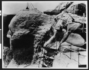 Scaffolding attached to Jefferson and Washington at unfinished Mount Rushmore, Black Hills, South Dakota, 1930-1940