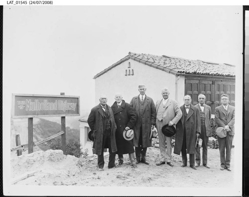 Harry Chandler and others pose near Mulholland Highway sign