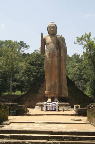 Standing Buddha statue at center of image house